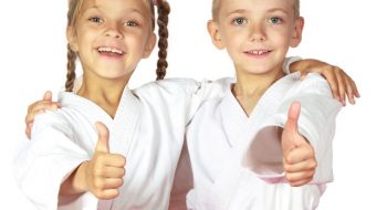 stock-photo-happy-boy-and-girl-athletes-karate-champions-142395820